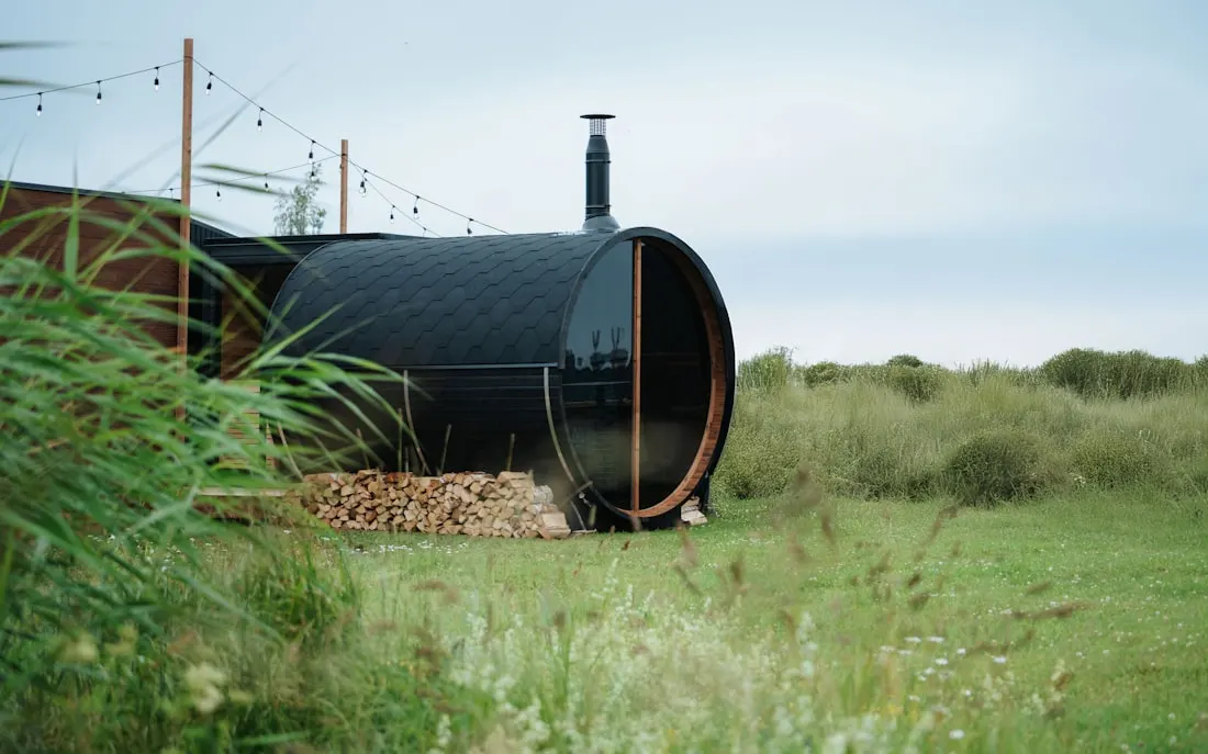A barrel sauna and a pod-style sauna compared