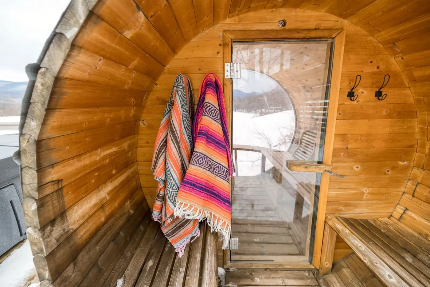 Inside a barrel sauna with bench seating