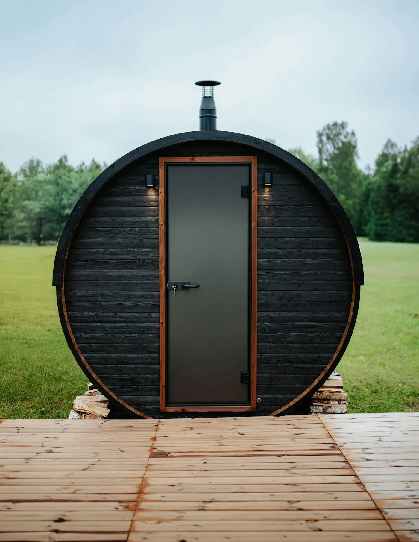 A barrel sauna on a prepared base outdoors