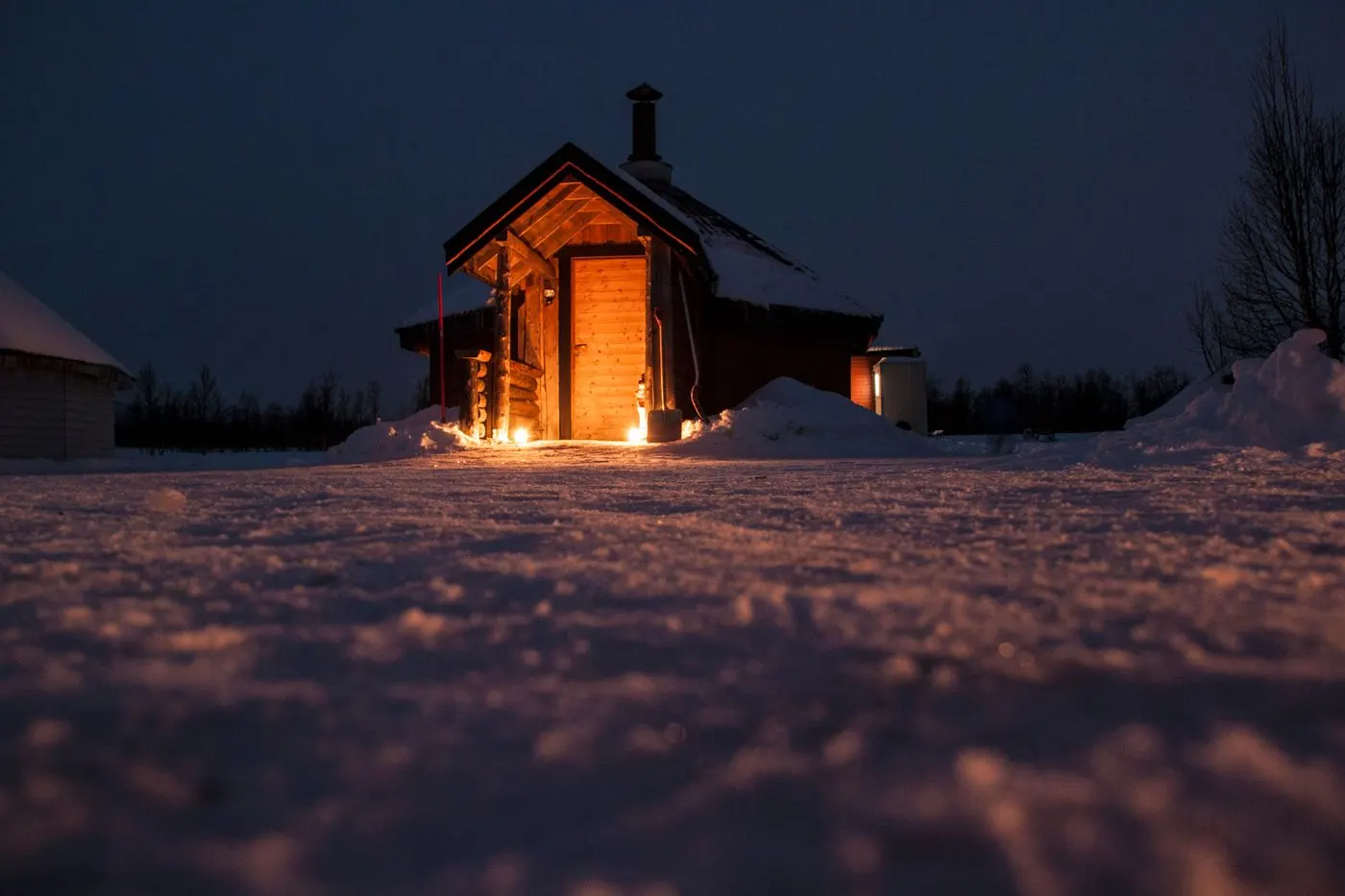 A cosy, glowing sauna on a winter night