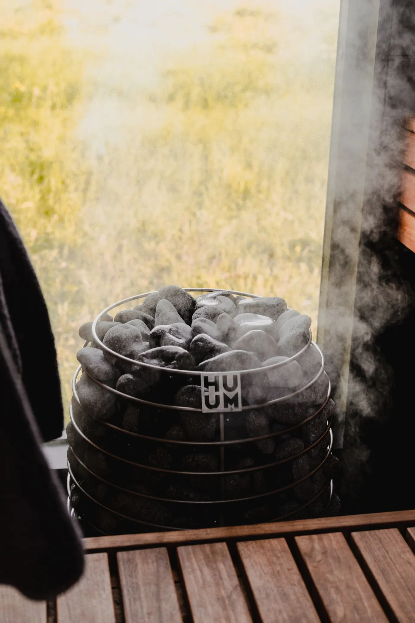 Steam rising from hot sauna stones