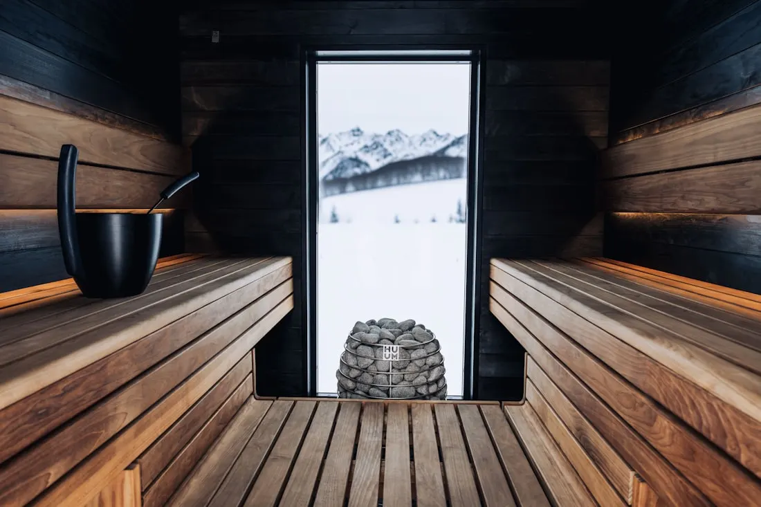 A sauna with a large glazed front looking out to snow