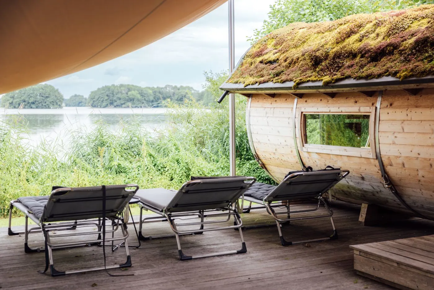 A lakeside outdoor sauna beside the water