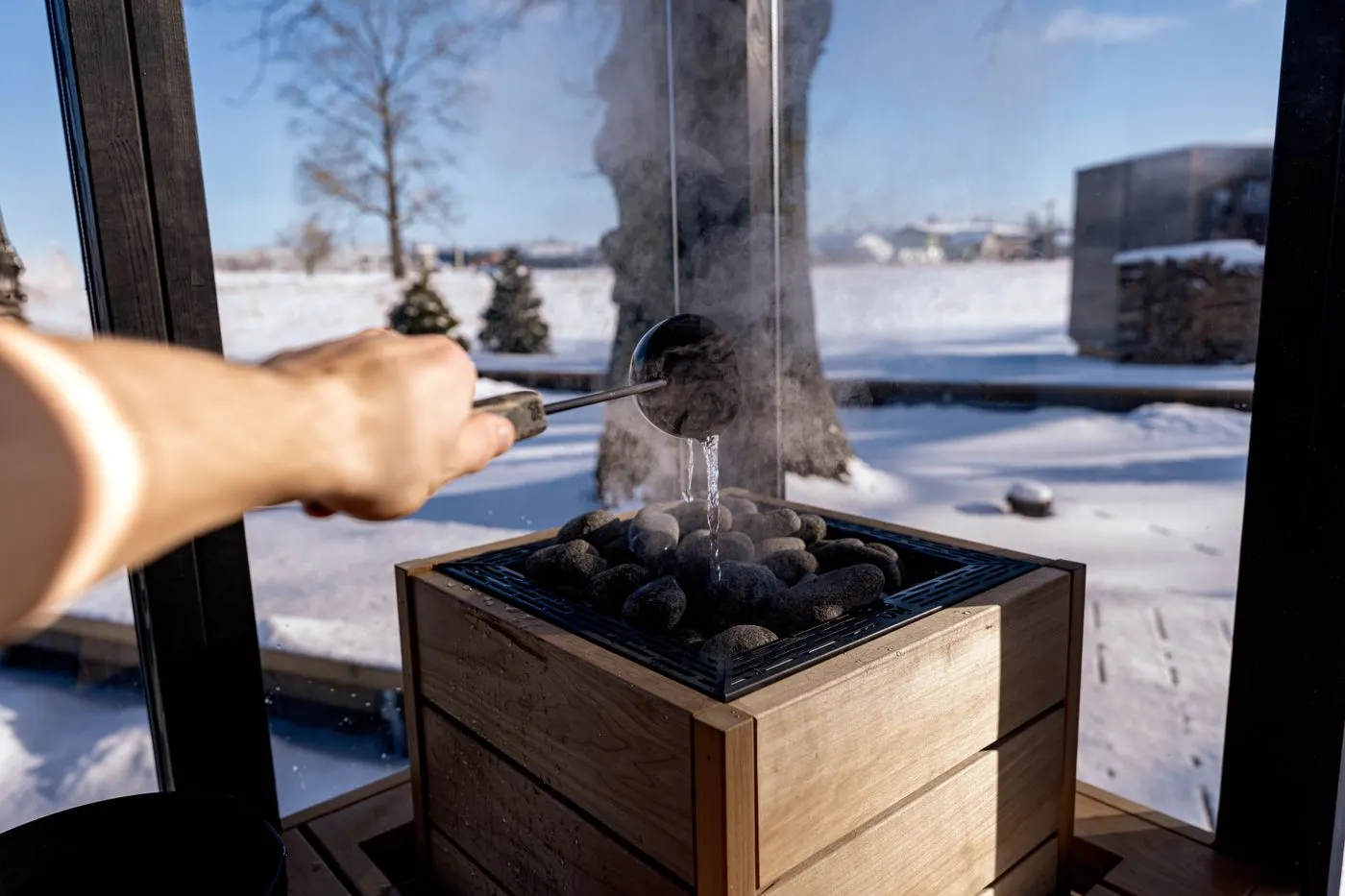 A safe winter cold plunge beside a sauna in the snow